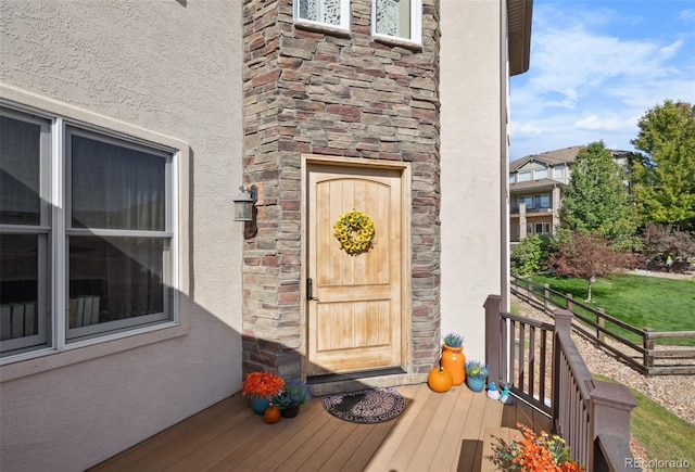 property entrance featuring a wooden deck