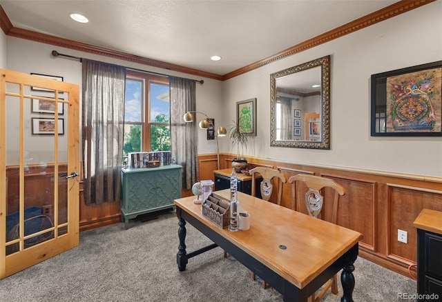 office with wooden walls, crown molding, and carpet flooring