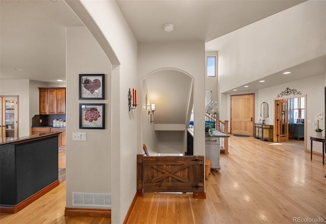 10215 W Wesley Dr, Lakewood, CO 80227 - hall with light wood-style flooring, recessed lighting, arched walkways, and visible vents