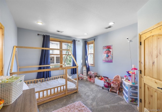 bedroom with a textured ceiling and carpet