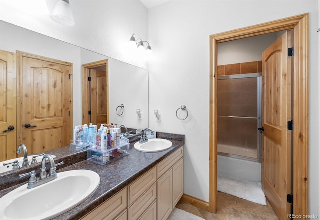 bathroom with enclosed tub / shower combo, vanity, and tile patterned floors