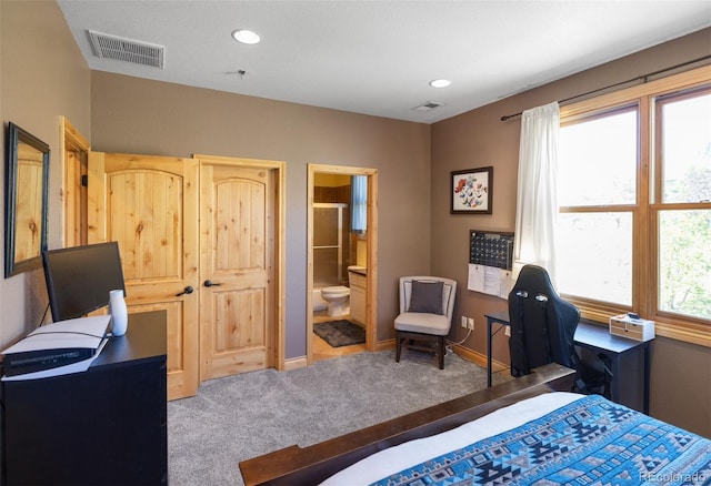 bedroom with carpet floors and ensuite bath