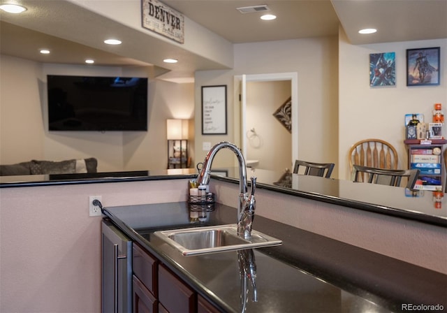 10215 W Wesley Dr, Lakewood, CO 80227 - interior space featuring a sink, recessed lighting, dark countertops, and visible vents