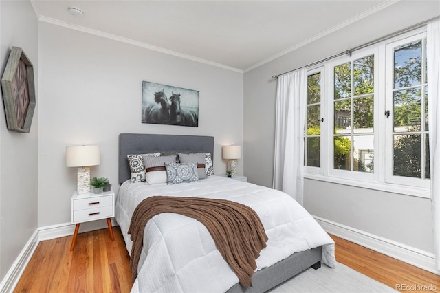 bedroom featuring wood-type flooring and crown molding