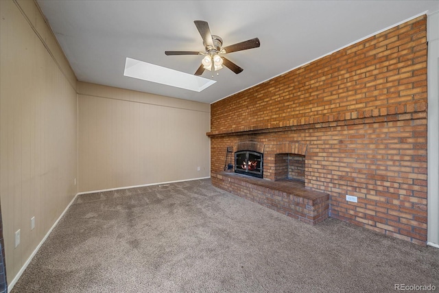 1923 S Newark Way, Aurora, CO 80014 - unfurnished living room with a ceiling fan, a skylight, carpet floors, a fireplace, and brick wall