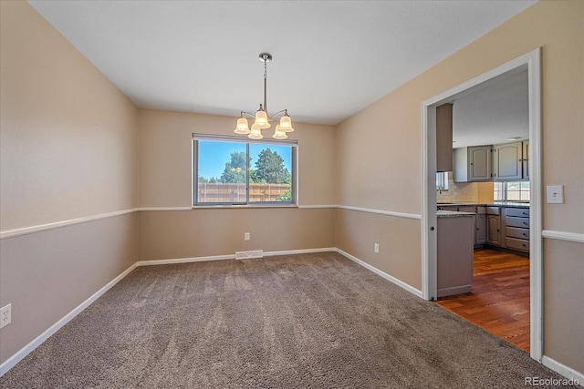 1923 S Newark Way, Aurora, CO 80014 - unfurnished room featuring a chandelier and dark colored carpet