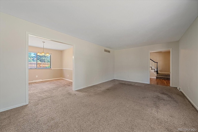 1923 S Newark Way, Aurora, CO 80014 - carpeted spare room featuring a chandelier and stairway