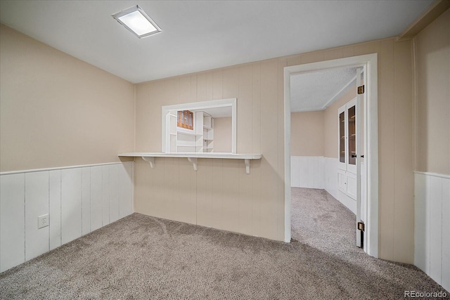 1923 S Newark Way, Aurora, CO 80014 - empty room featuring carpet flooring, wainscoting, and a decorative wall