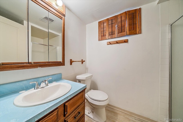 1923 S Newark Way, Aurora, CO 80014 - bathroom with wood finished floors, vanity, and a shower with door