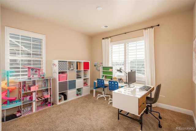 carpeted office featuring visible vents and baseboards