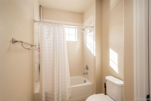 bathroom featuring toilet and shower / bathtub combination with curtain