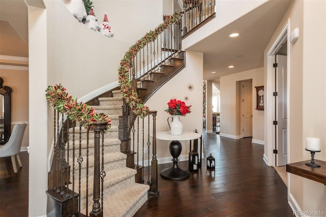 foyer entrance with stairs, baseboards, hardwood / wood-style floors, and recessed lighting