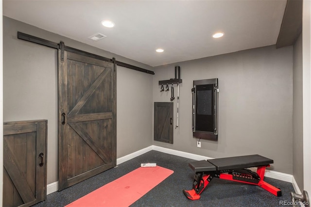 workout room with recessed lighting, visible vents, baseboards, and a barn door