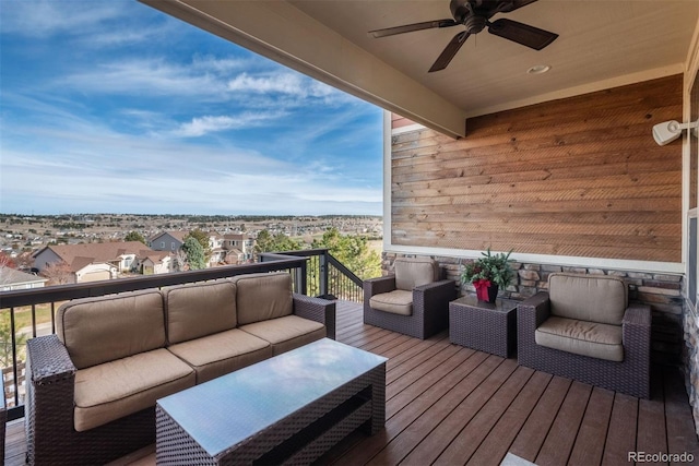 wooden deck with a ceiling fan and an outdoor living space