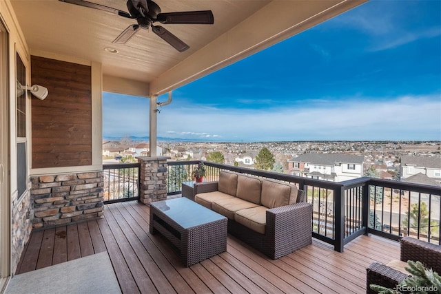 deck featuring outdoor lounge area, a residential view, and a ceiling fan