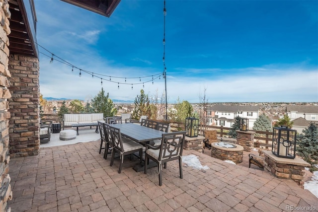 view of patio / terrace with outdoor dining space and an outdoor living space with a fire pit