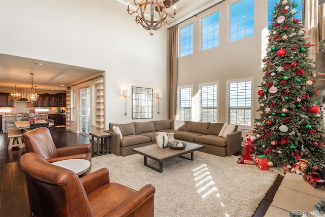 living room featuring a high ceiling and an inviting chandelier