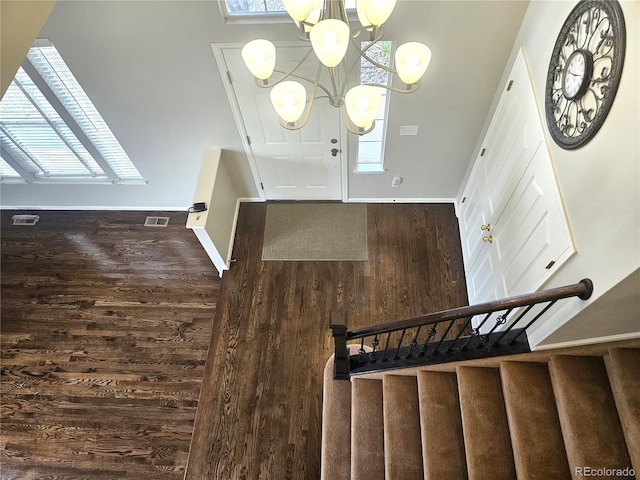 entryway featuring wood finished floors, baseboards, and visible vents