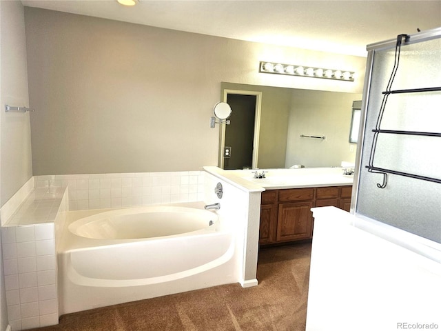 full bath featuring a garden tub and vanity