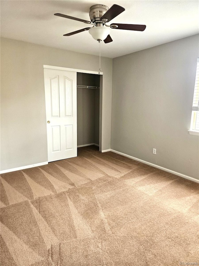 unfurnished bedroom with carpet floors, baseboards, and a closet