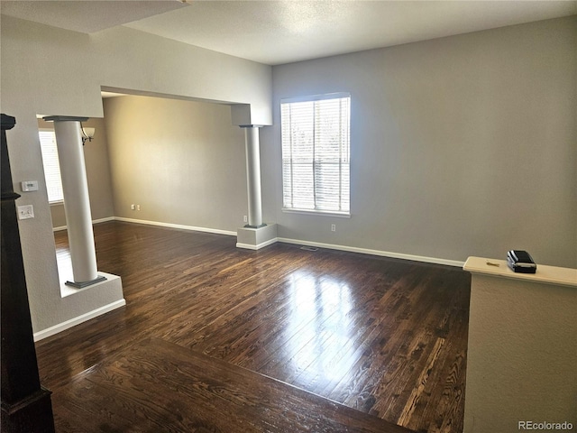 21580 Longs Peak Ln, Parker, CO 80138 - spare room featuring decorative columns, wood finished floors, and baseboards