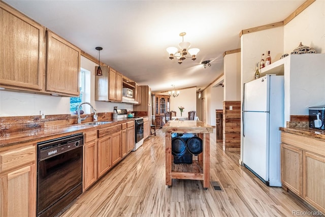 kitchen featuring white fridge, range with gas cooktop, black dishwasher, a notable chandelier, and pendant lighting