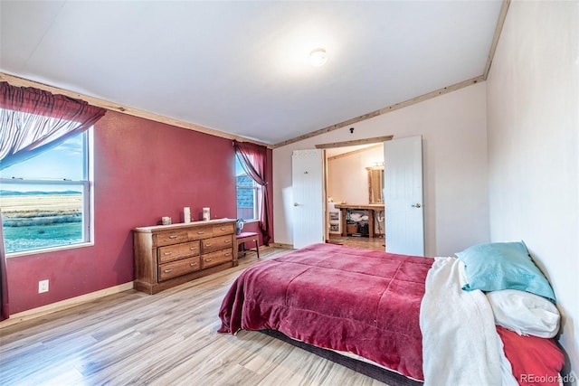 bedroom with light wood-style flooring and baseboards