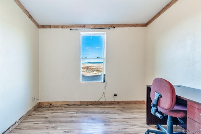 office featuring baseboards, light wood-style flooring, and crown molding