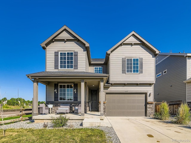 607 Azalea St, Brighton, CO 80601 - view of front facade with a porch, an attached garage, concrete driveway, stone siding, and a shingled roof