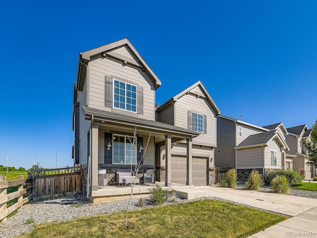 607 Azalea St, Brighton, CO 80601 - traditional home with covered porch, stone siding, driveway, and a garage