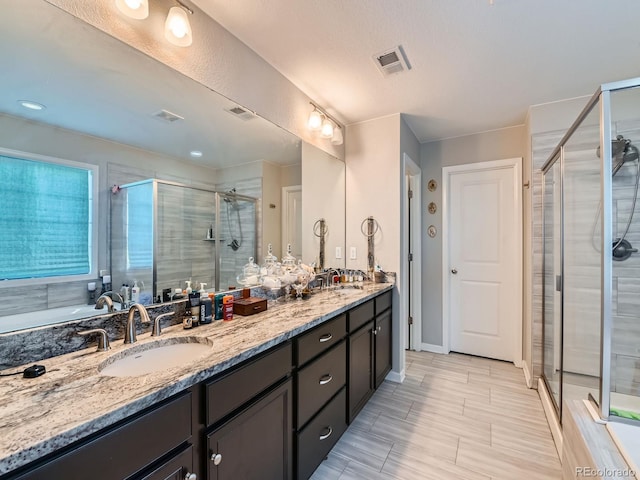 607 Azalea St, Brighton, CO 80601 - bathroom featuring double vanity, a stall shower, and a garden tub