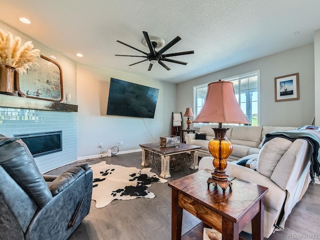 607 Azalea St, Brighton, CO 80601 - living room featuring a ceiling fan, wood finished floors, a fireplace, a textured ceiling, and recessed lighting