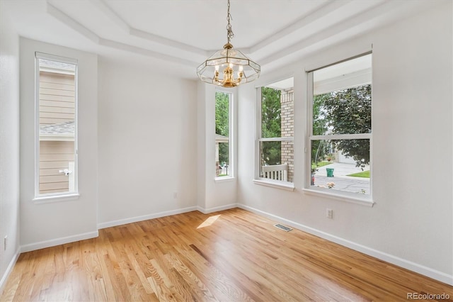 11237 W Ford Dr, Lakewood, CO 80226 - unfurnished room featuring a chandelier, wood finished floors, and a raised ceiling