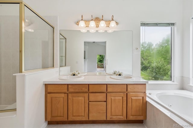 11237 W Ford Dr, Lakewood, CO 80226 - full bath featuring a jetted tub, tiled shower, and double vanity