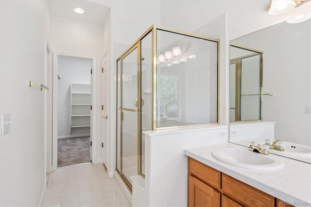 11237 W Ford Dr, Lakewood, CO 80226 - bathroom with a shower stall, vanity, and a spacious closet