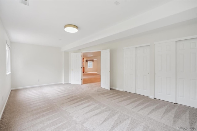 11237 W Ford Dr, Lakewood, CO 80226 - unfurnished bedroom with carpet floors and two closets