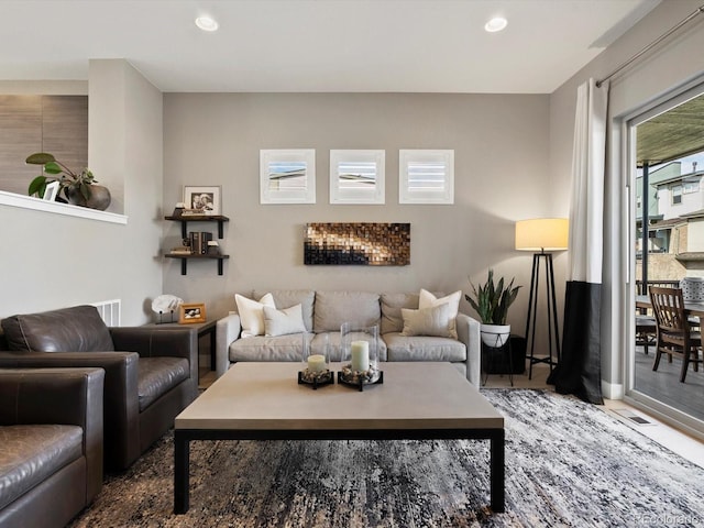 living area with visible vents and recessed lighting