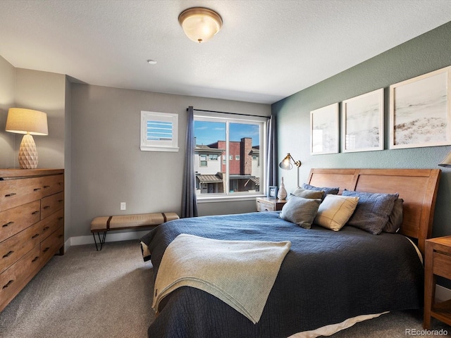 carpeted bedroom with a textured ceiling and baseboards