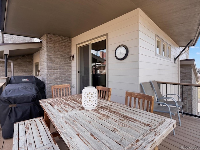 deck with grilling area and outdoor dining space