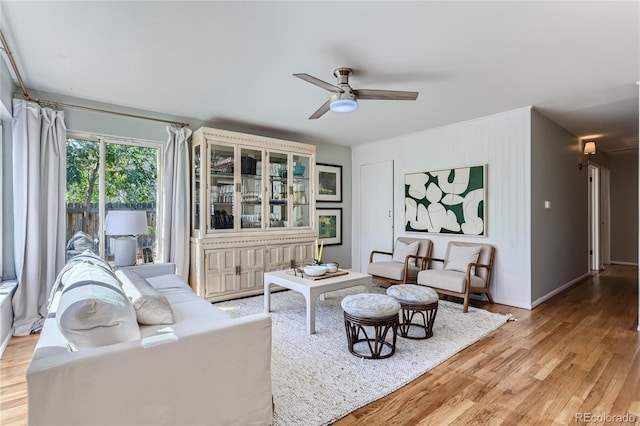 living room with ceiling fan and light wood-type flooring