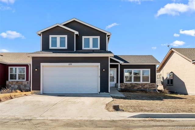 view of front of property with stone siding, concrete driveway, and an attached garage