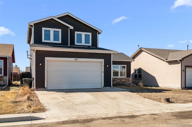 view of front of home with a garage, driveway, and fence