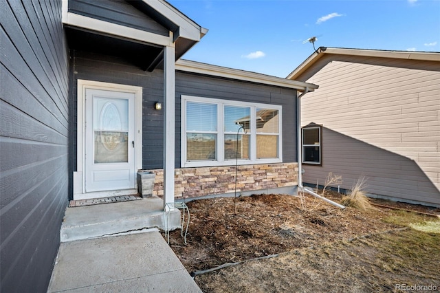 doorway to property with stone siding