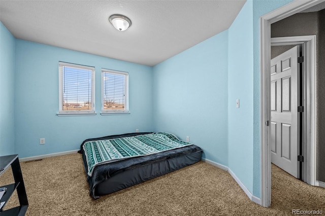 carpeted bedroom featuring baseboards