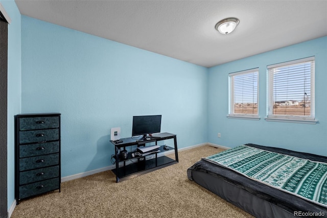 carpeted bedroom featuring baseboards