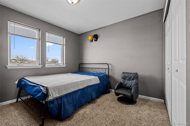 bedroom with carpet, a closet, and baseboards