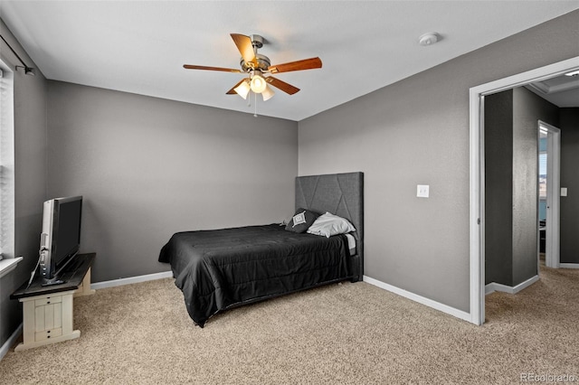 bedroom featuring light carpet, baseboards, and a ceiling fan