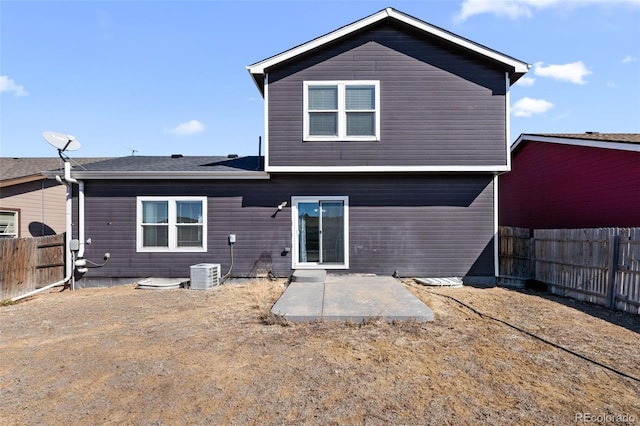 back of house with a patio area, a fenced backyard, and central air condition unit