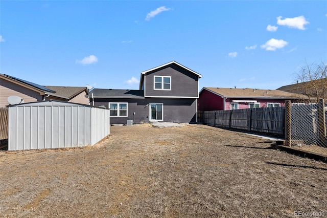 rear view of house with fence