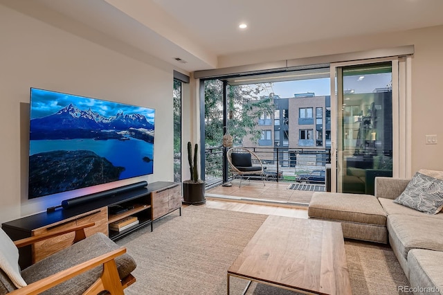 living area with visible vents, recessed lighting, and wood finished floors